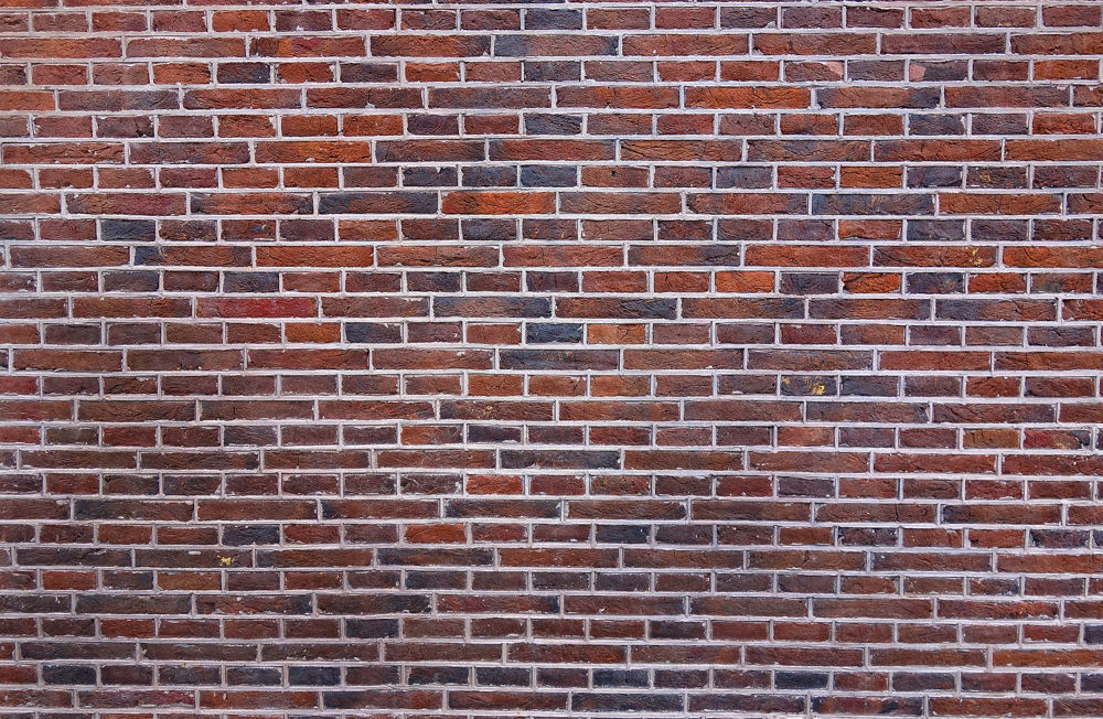 A beautifully restored brick wall on a commercial building.