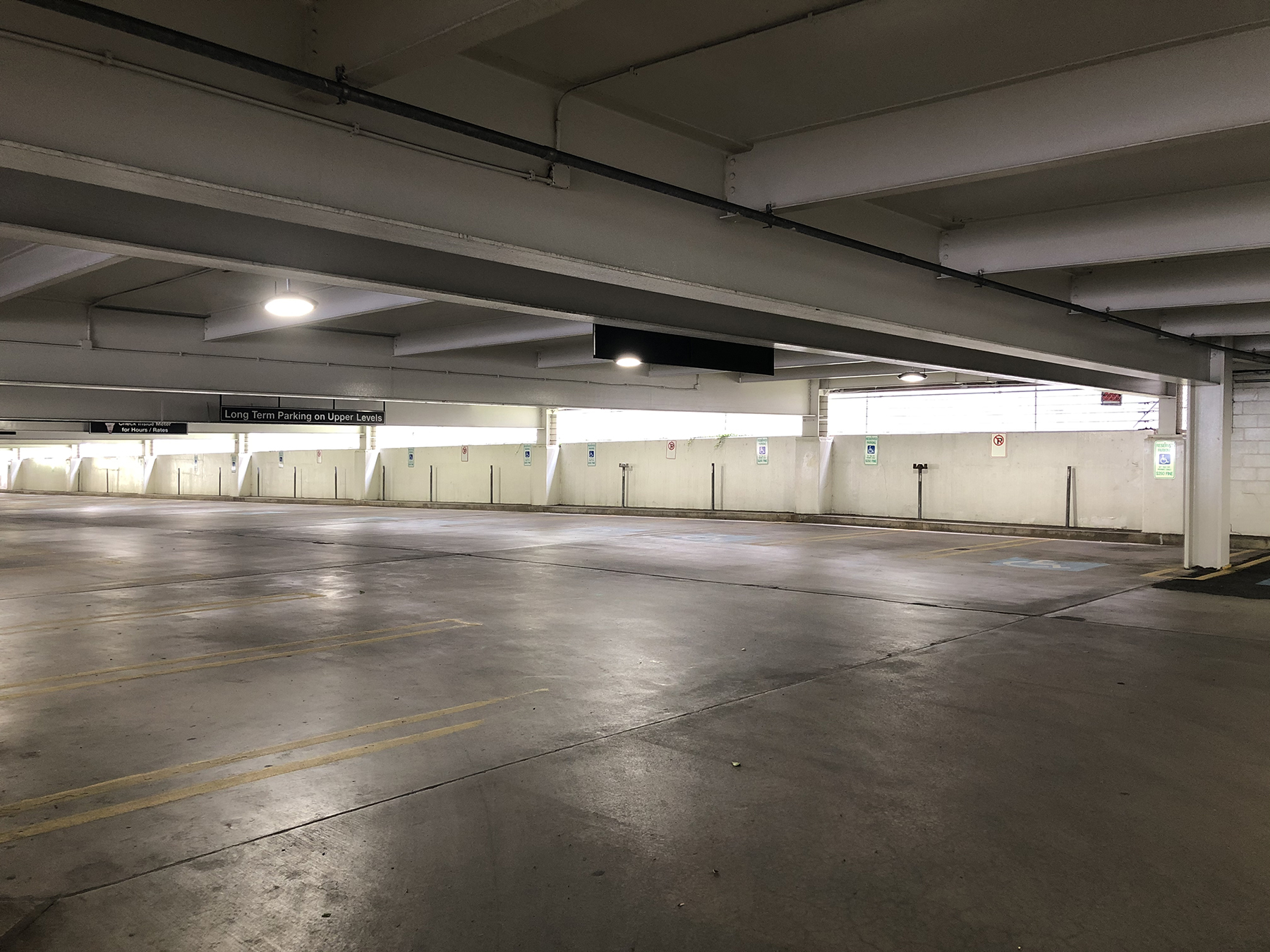 The interior of a clean, well-lit commercial parking garage.