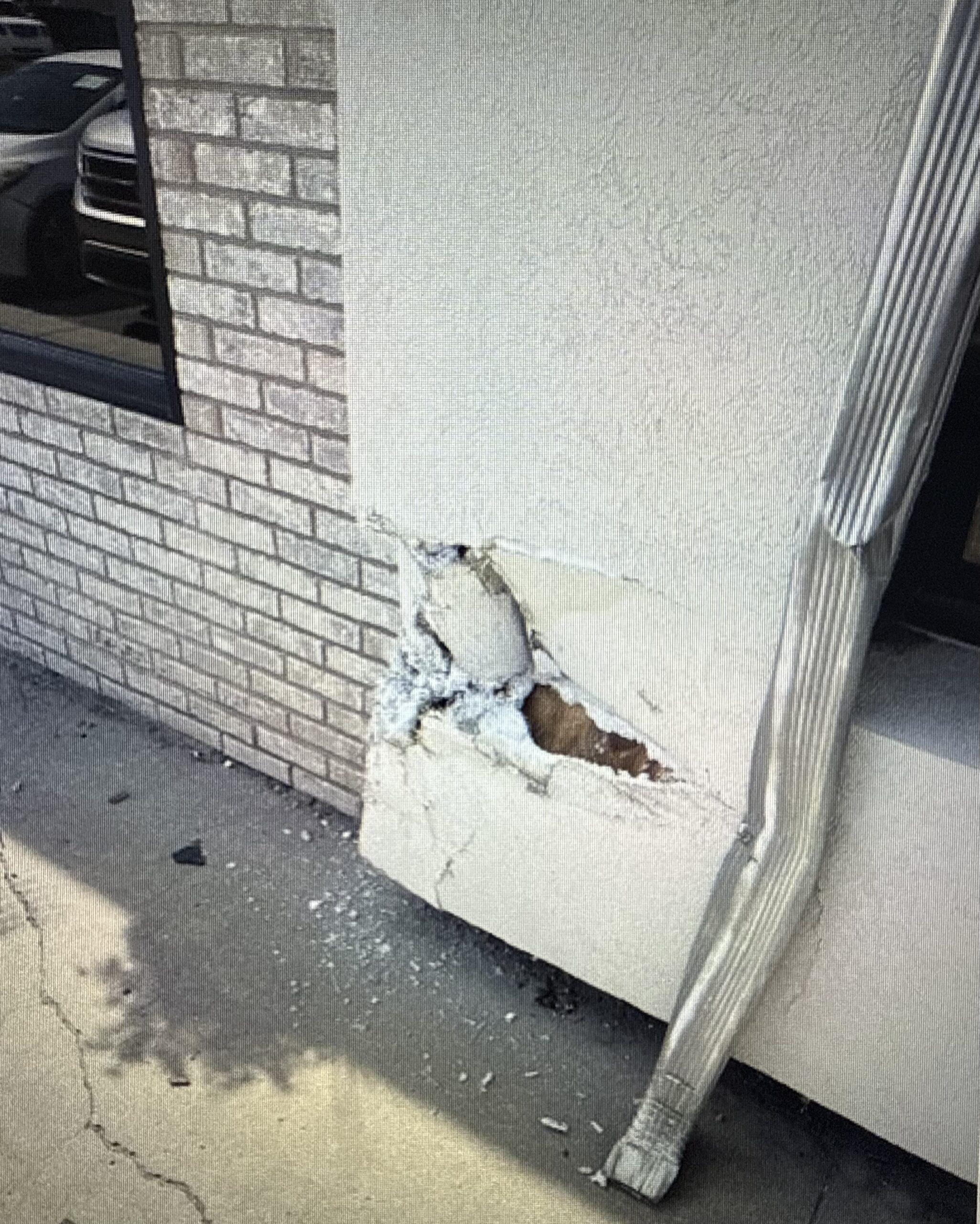 A commercial building facade with visible staining and discoloration before cleaning.